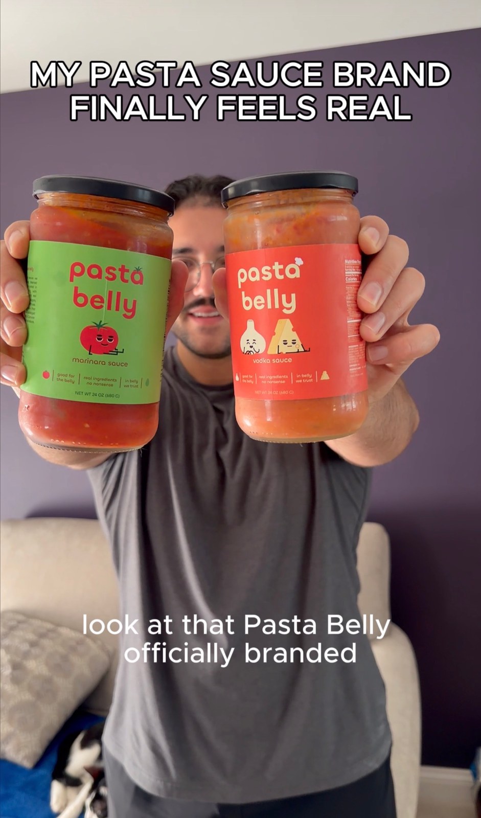 Anthony holding Pasta Belly Marinara and Vodka sauce jars